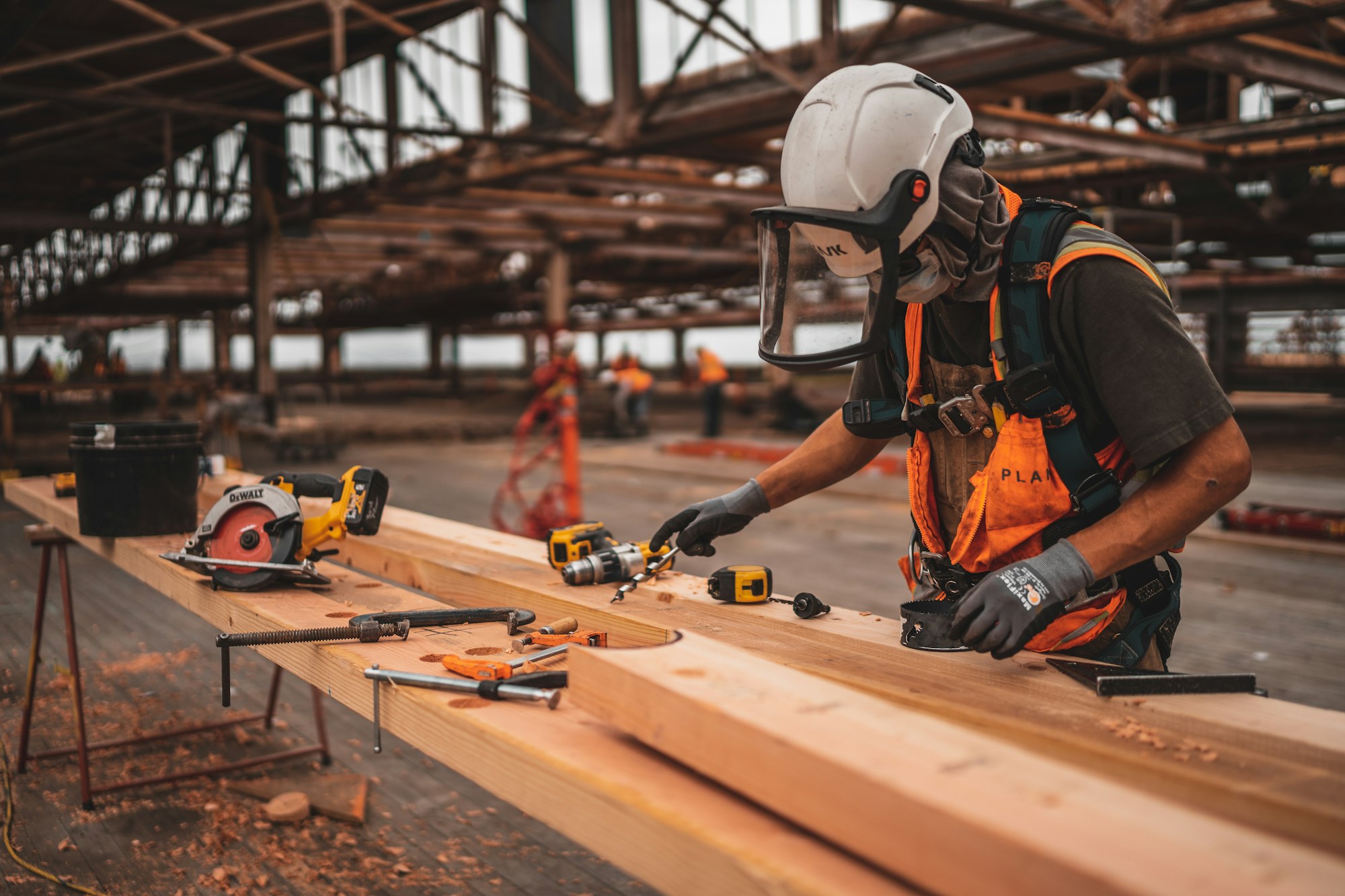 Carpenter cutting lumber on a job site Carpenter cutting lumber on a job site