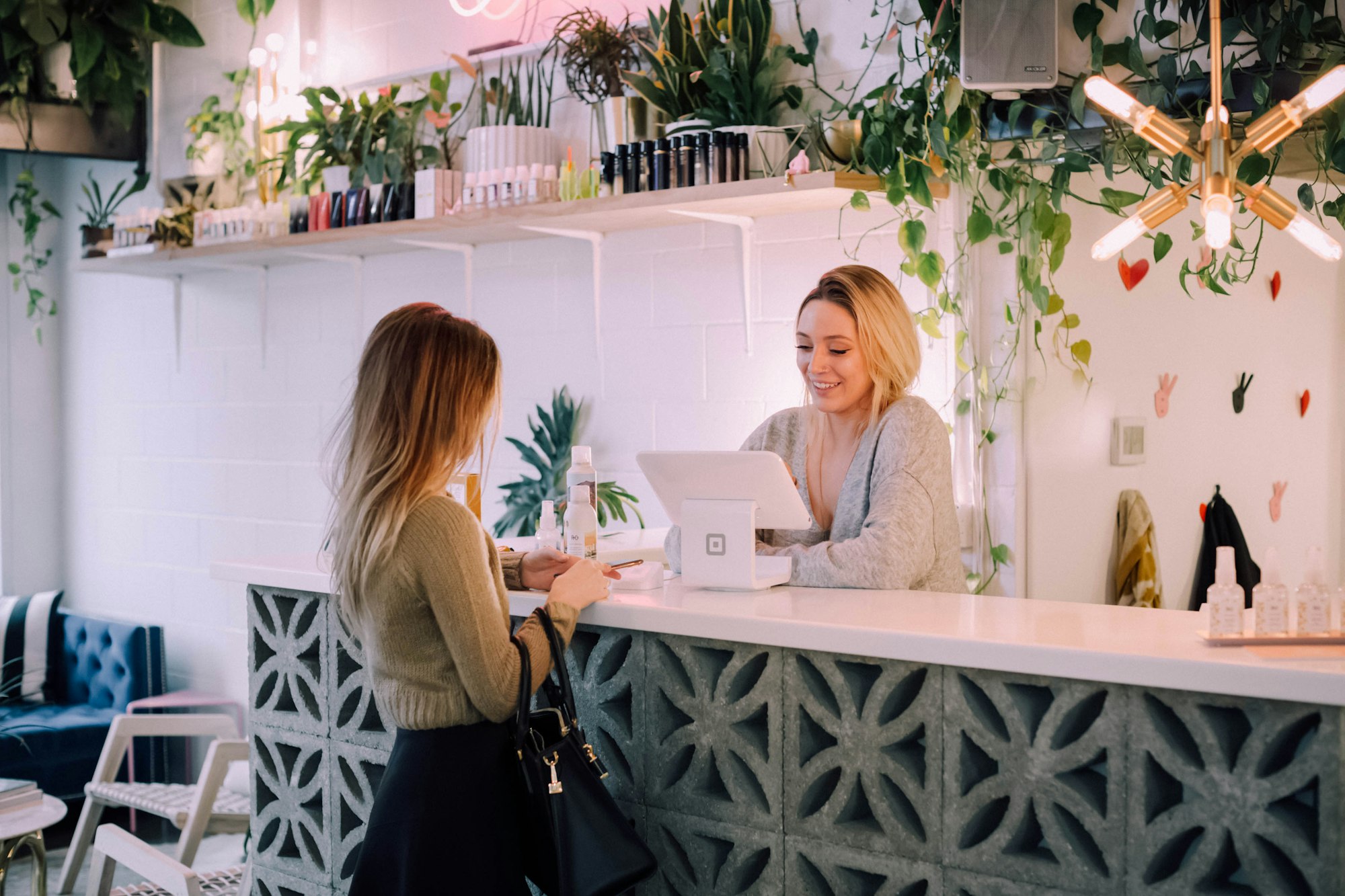 Client paying at a front desk with a tablet point of sale Client paying at a front desk with a tablet point of sale