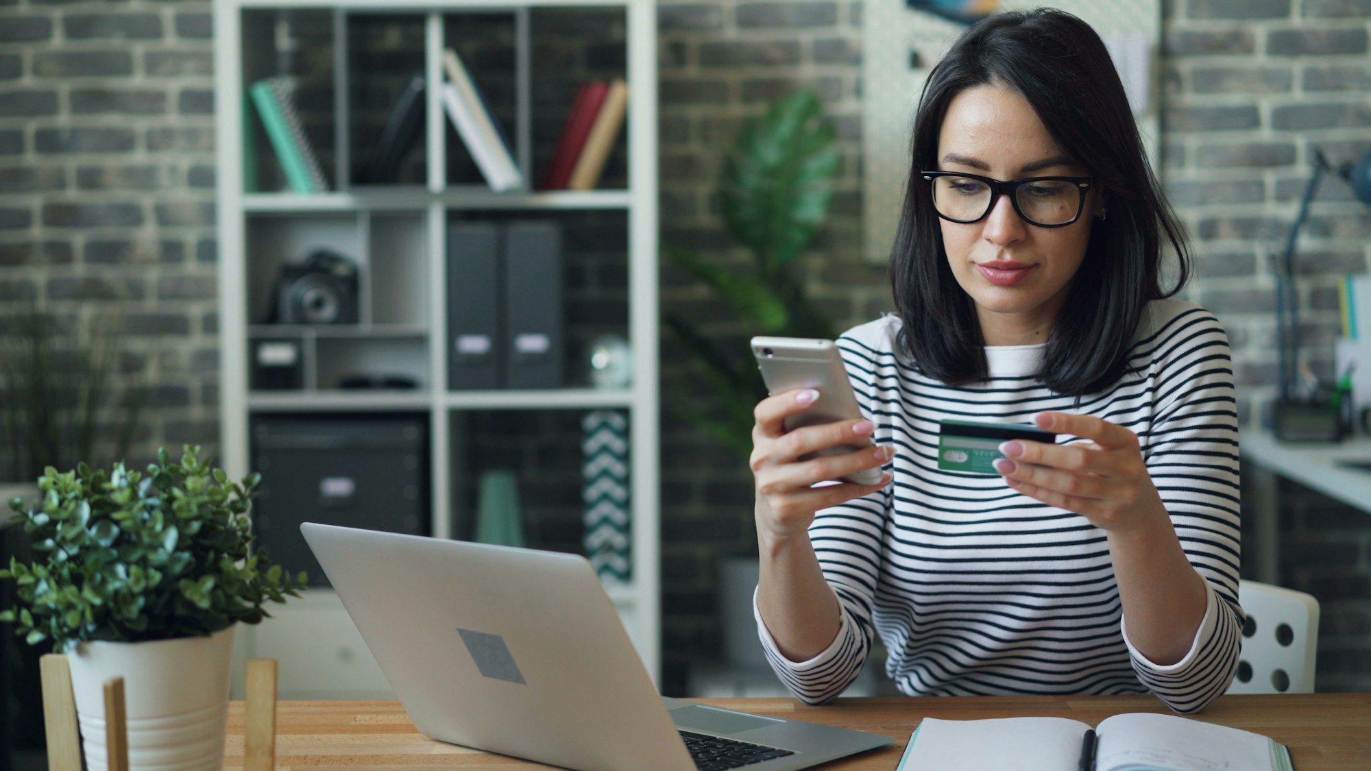 Customer paying online with a credit card and phone