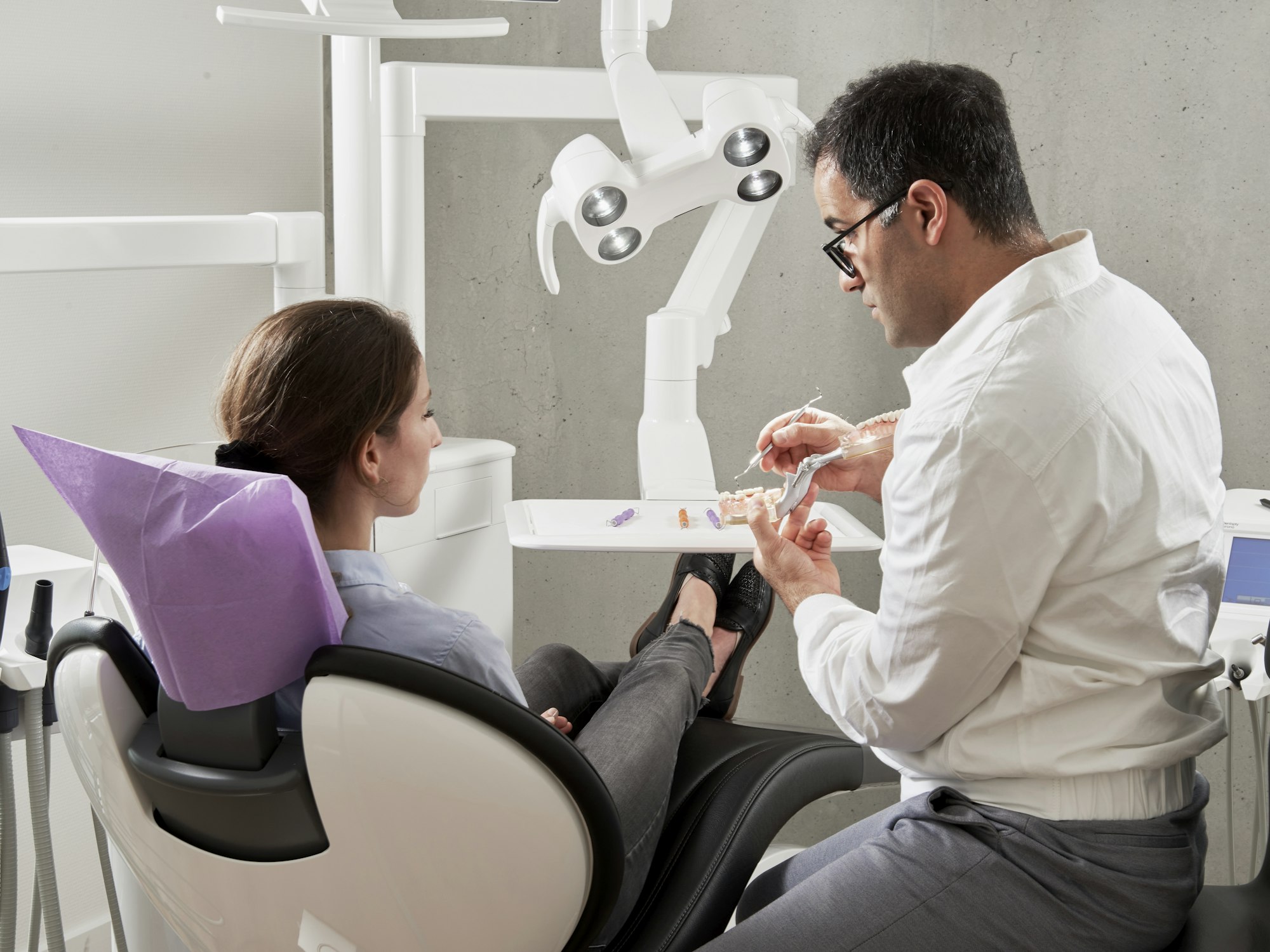 Dentist explaining a treatment plan to a patient Dentist explaining a treatment plan to a patient
